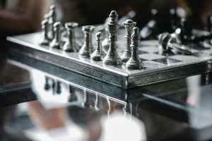 metal carved chess board with set pieces