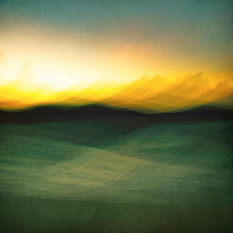 a sunset over a field with a blurry image